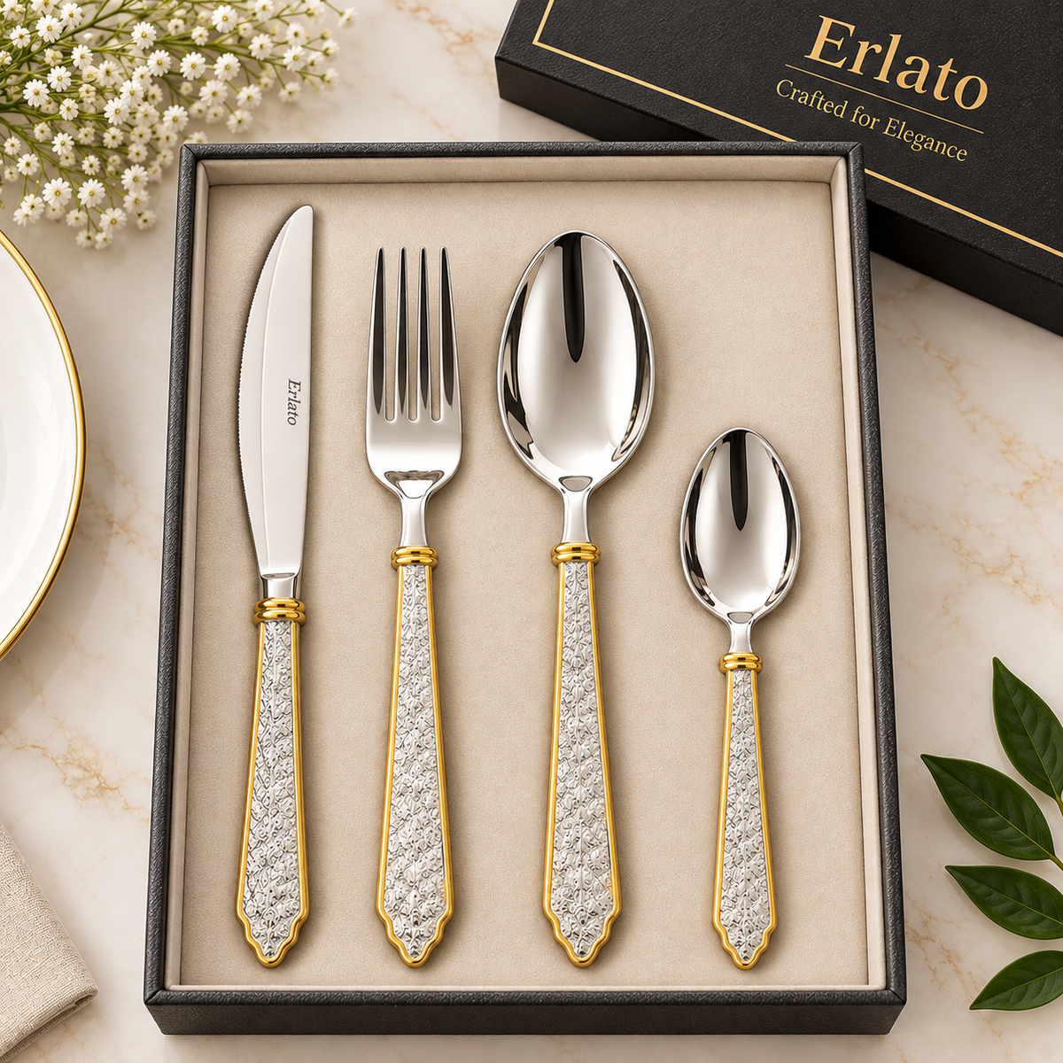 Erlato 4-piece gold and silver cutlery set with ornate gold-trimmed handles in a luxury beige velvet gift box